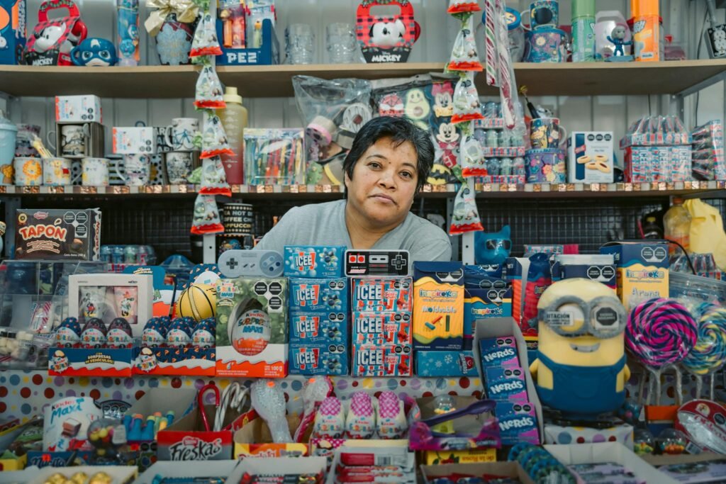 Woman in a vibrant Mexico City toy shop surrounded by merchandise.